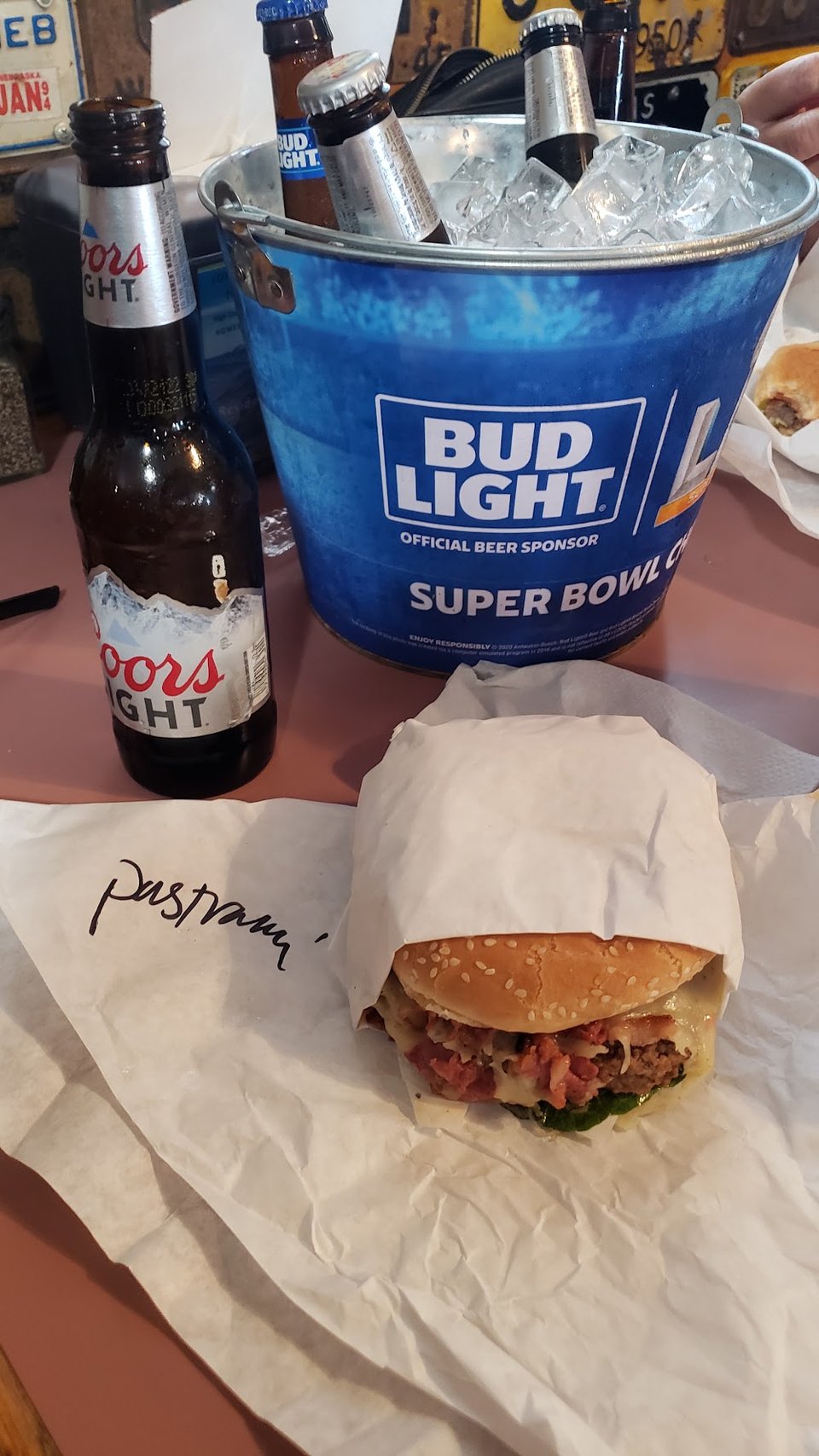 Close-up of a menu with wings, salads, and burgers.