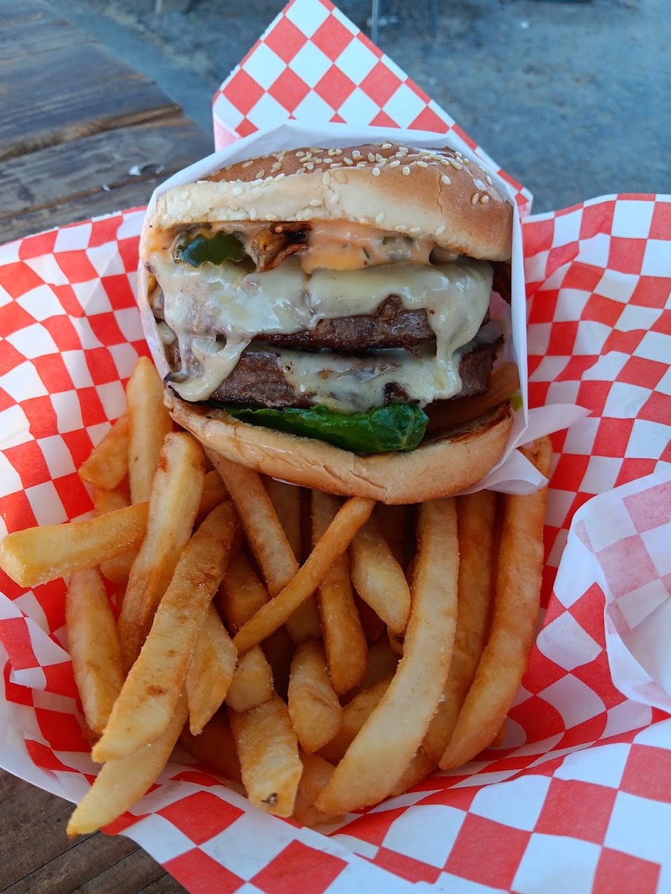 Close-up of a menu with wings, salads, and burgers.